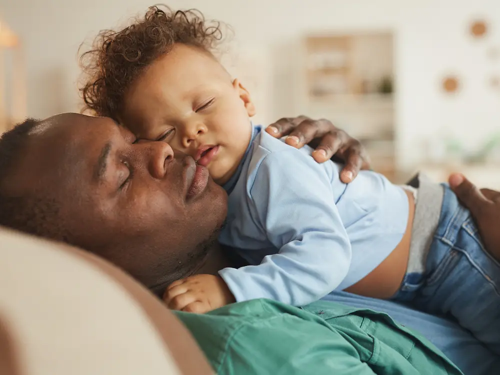 A father cuddles with his baby.